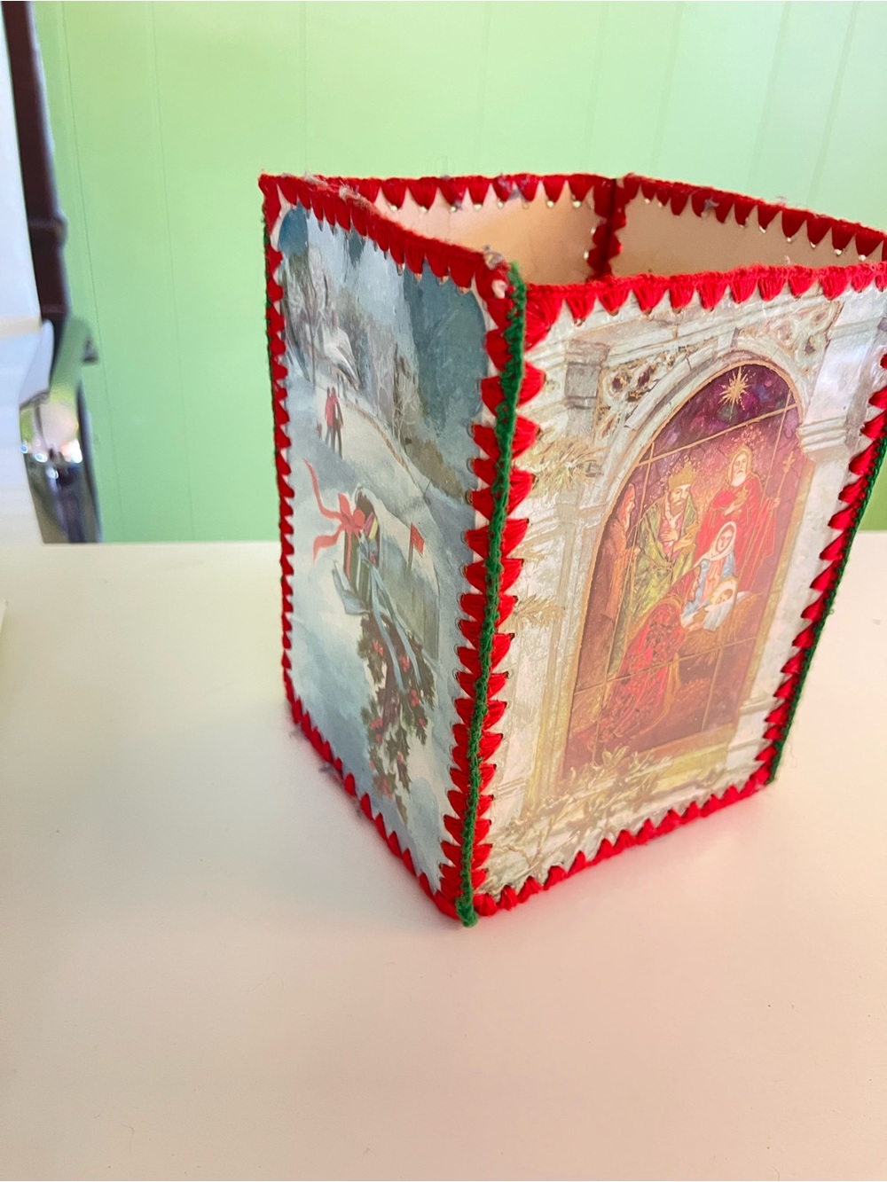 Vintage, handmade Christmas card basket. 4 panels and stitched with red yarn.